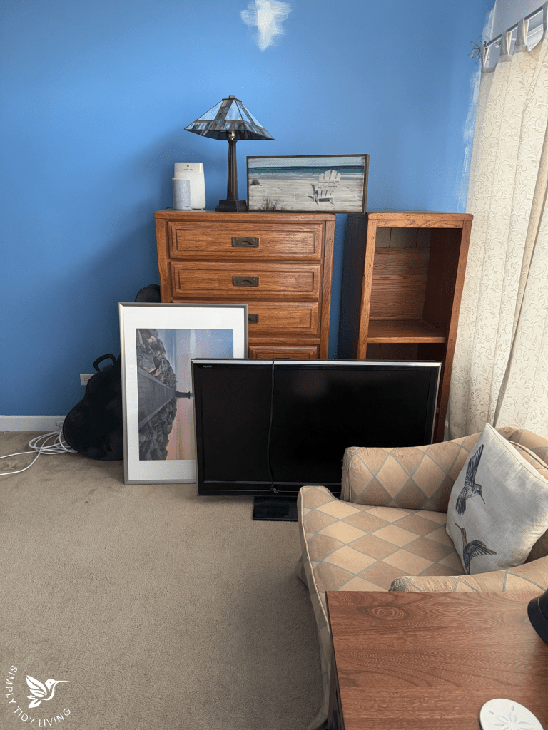 A significantly decluttered bedroom with neatly arranged furniture, clear surfaces, and an organized space, showing a realistic improvement.